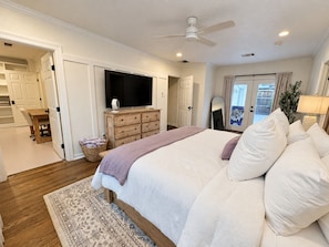 A bedroom with a bed, a dresser, a television, and a ceiling fan. - Walk To Tcu-Sleeps 8- 2king Beds- 2 Car Garage-Fenced Backyard (Fort Worth)