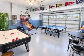 A recreational room with a foosball table, ping pong tables, and a basketball hoop. - ChampionsGate 6BR Pool, Spa & Games (Four Corners)