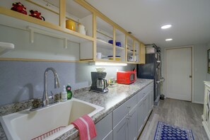 A kitchen with a sink, a coffee maker, and a microwave on the countertop. - 4-Unit Group Retreat! 2 Hot Tubs & Walk to Beach (Hansville)