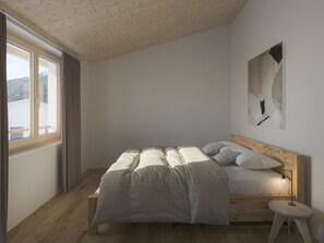 A bedroom with a bed, a bedside table, a window, and a wall-mounted artwork.