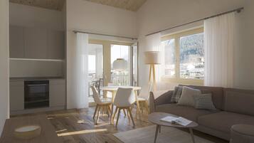 Ein modernes Wohnzimmer mit Sofa, Couchtisch und Essbereich.