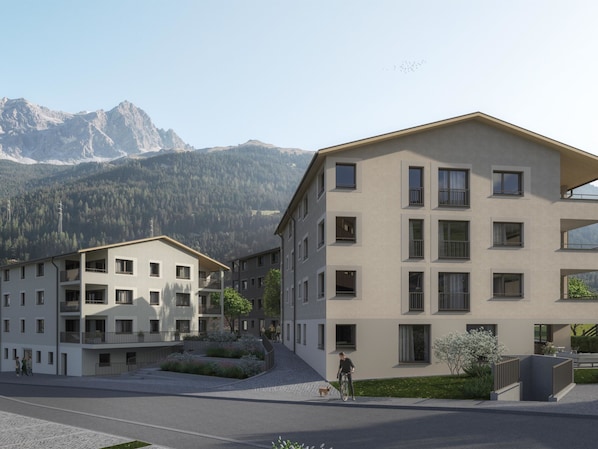 A multi-story residential building with a flat roof, large windows, and a paved courtyard. - Residenza Grava Appartement/Fewo, Dusche, WC, 1 Schlafraum by Interhome (Savognin)