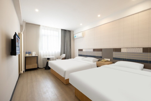 A hotel room with two beds, a desk, a chair, a TV, and an air conditioning unit. - Homeinn (Beijing)