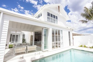 A two-story house with a covered patio and a swimming pool. - Bianca dal Mare- Stunning Beachside Retreat in Casuarina (Casuarina)