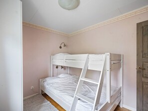 A bunk bed room with a ladder, a wall-mounted lamp, and a door. - Backa Gård by Interhome (Lur)