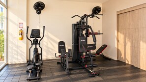 A gym with cardio equipment, weight machines, and a bench. - Experience Cartagena History Caribbean Flavors and Relaxation in Serena del Mar (Cartagena Province)
