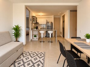 A modern apartment with a living room, a dining area, and a kitchen. - Experience Cartagena History Caribbean Flavors and Relaxation in Serena del Mar (Cartagena Province)