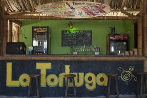 A bar named 'La Tortuga' with a chalkboard menu, a refrigerator, and a Coca-Cola cooler. - Private room - 4 people, pool & sea view (Santa Marta)