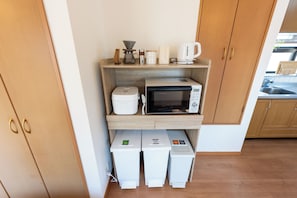 A compact kitchenette with a microwave, coffee maker, and storage bins. - Opening Sale | Private Rental House | 3 Minutes to the Beach, 5 Minutes to the Station | Ideal for Sightseeing in Enoshima and Kamakura (藤沢市)