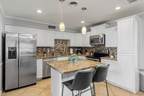 A modern kitchen with white cabinetry, a stainless steel refrigerator, a built-in microwave, and a granite countertop. - Sleeps 12, Private Pool,BBQ (Tempe)