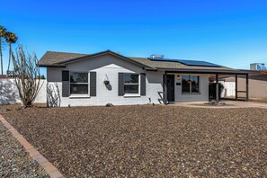 A single-story house with a sloped roof, a covered porch, and solar panels on the roof. - Sleeps 12, Private Pool,BBQ (Tempe)