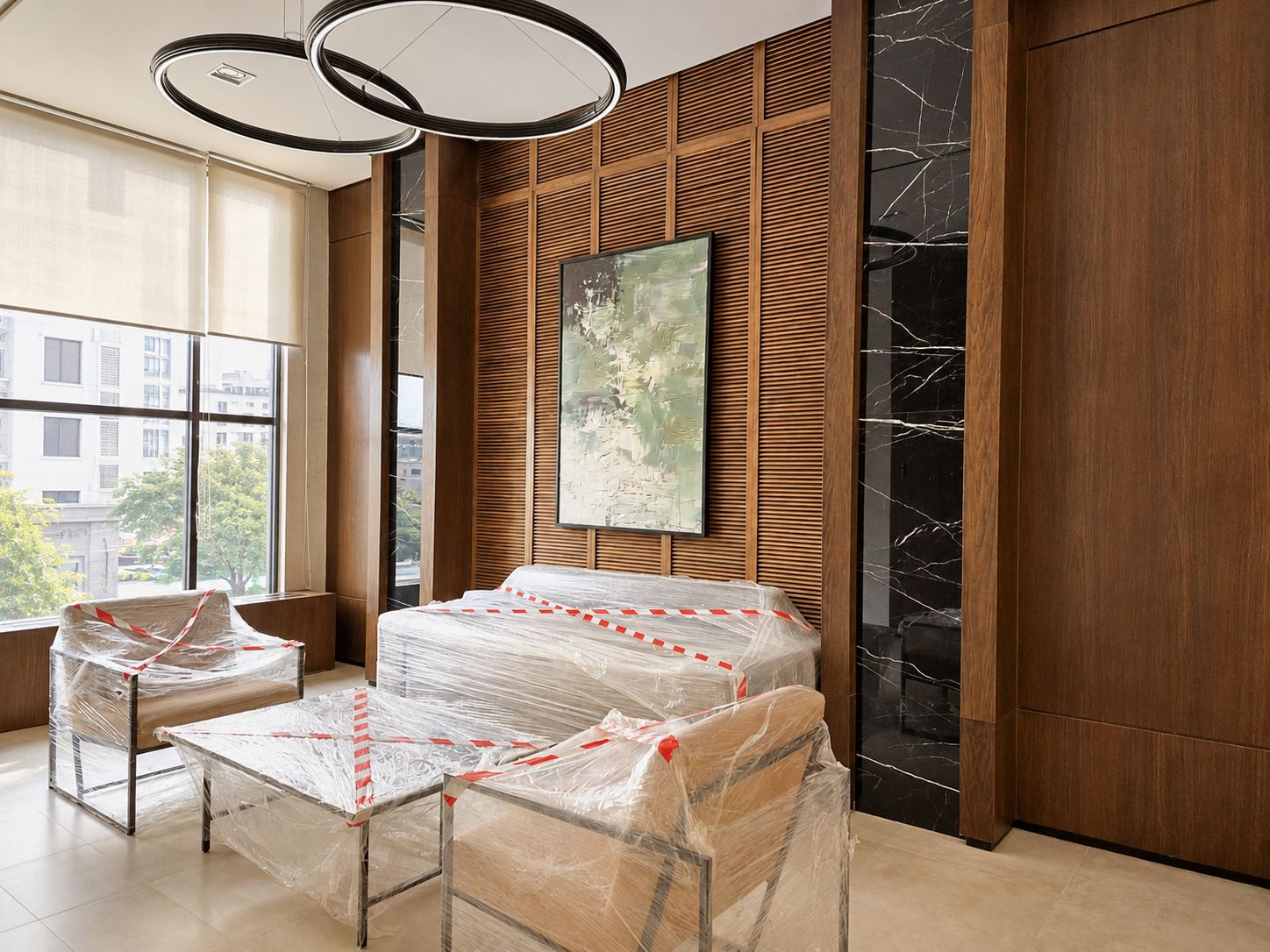 A modern hotel room with a bed, two chairs, a large window, and a marble wall.