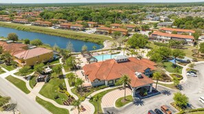 Um bairro residencial com piscina, um gazebo e vista para um lago.