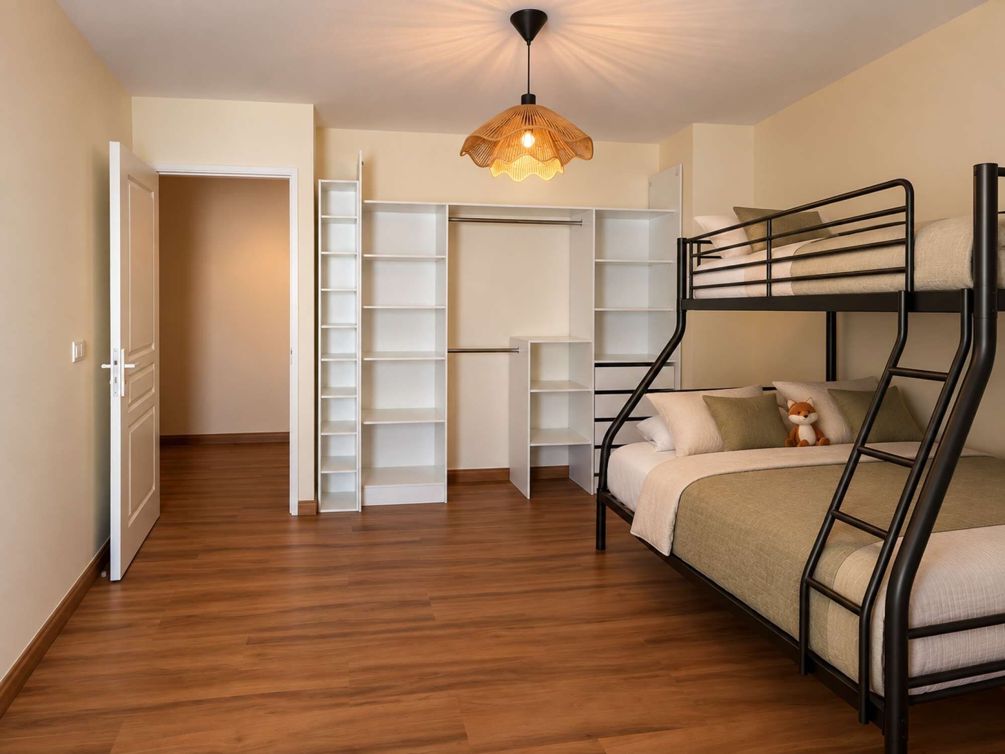 A room with a bunk bed, a wardrobe with multiple shelves, and a hanging light fixture.