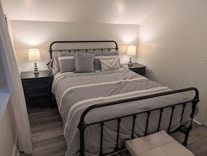 A bedroom with a bed, two bedside tables, two lamps, a bench, and a nightstand. - NEW!  The Deer and Birches Combination - 2 Beautiful Houses on the Same Property! (Frankfort)