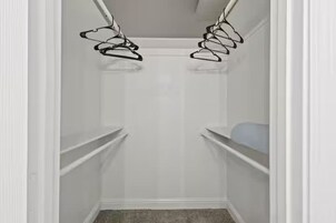 A closet with two sets of hanging storage racks.