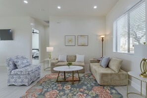 A modern living room with a sofa, armchair, and a coffee table.