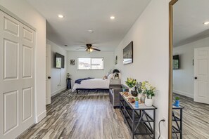 A bedroom with a bed, a desk, a chair, a ceiling fan, and a window. - Desert Oasis: Home Near Joshua Tree NP! (Twentynine Palms)