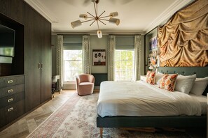 A bedroom with a bed, a chair, a television, and a window. - Home Away From Holmes - Cosy 3 Bedroom Marylebone (London)