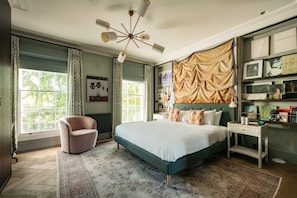 A bedroom with a large bed, a chair, a desk, and a bookshelf. - Home Away From Holmes - Cosy 3 Bedroom Marylebone (London)