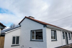 A residential building with a white exterior, a brown roof, and multiple windows. - entire 3 bed home on the outskirts of Donegal Town (Donegal Town)