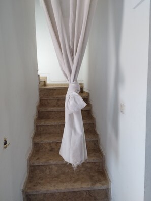 A staircase with a white curtain tied at the top. - STUNNING VILLA - 4 BEDROOMS - PRIVATE POOL - QUIET LOCATION (Unknown)