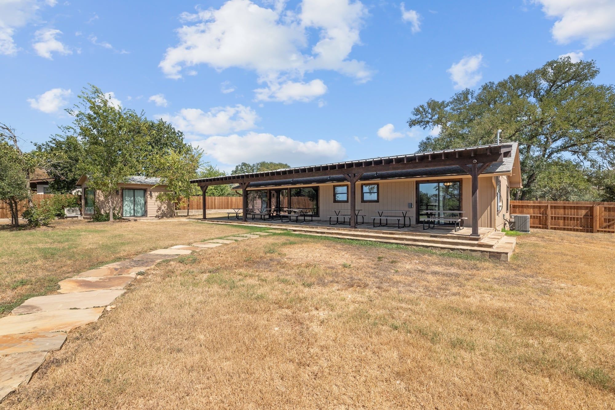 A covered patio area with outdoor seating.