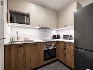A modern kitchen with a built-in microwave, oven, and toaster. - Bright central apartment - 4 guests (Val-d'Isère)