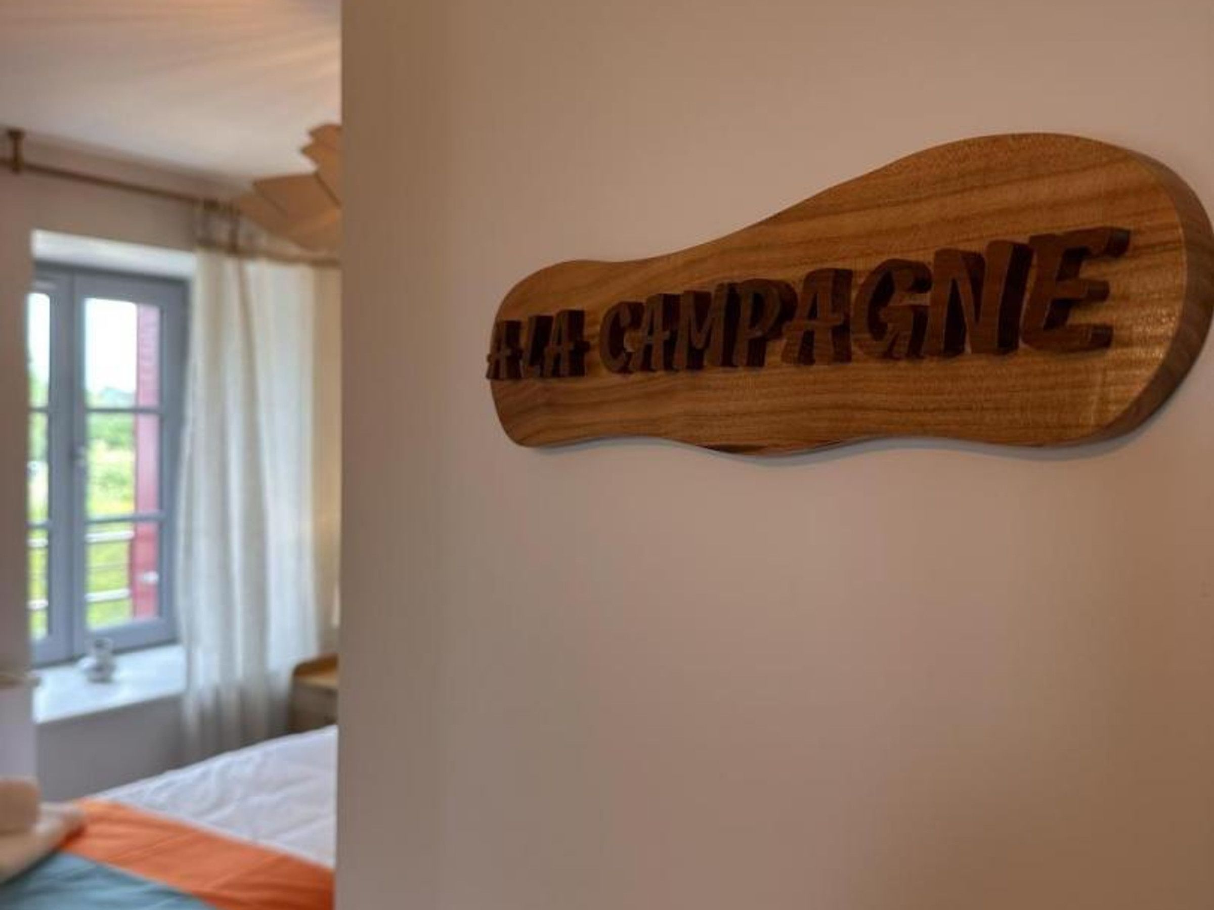 A wooden sign with the text 'CHAMPAGNE' on a wall.