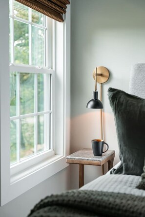 A room with a window, a lamp, a small table, and a bed. - Hop Inn Private Hot Tub Fire Pit Mtn Views (Waynesville)