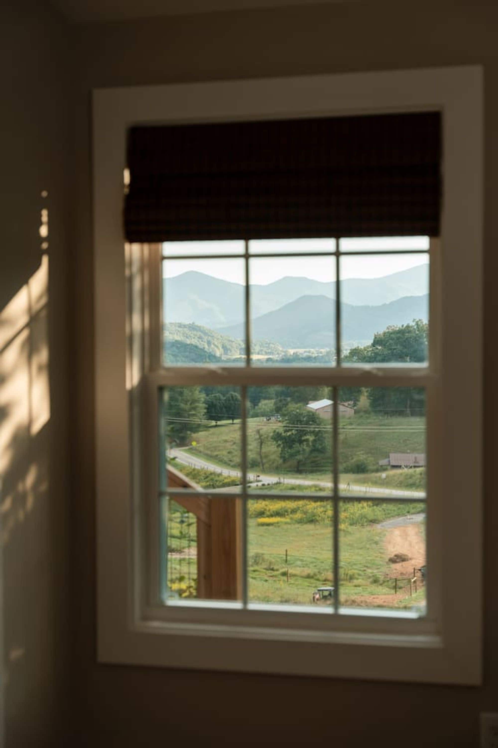 A window with a view of a mountainous landscape.