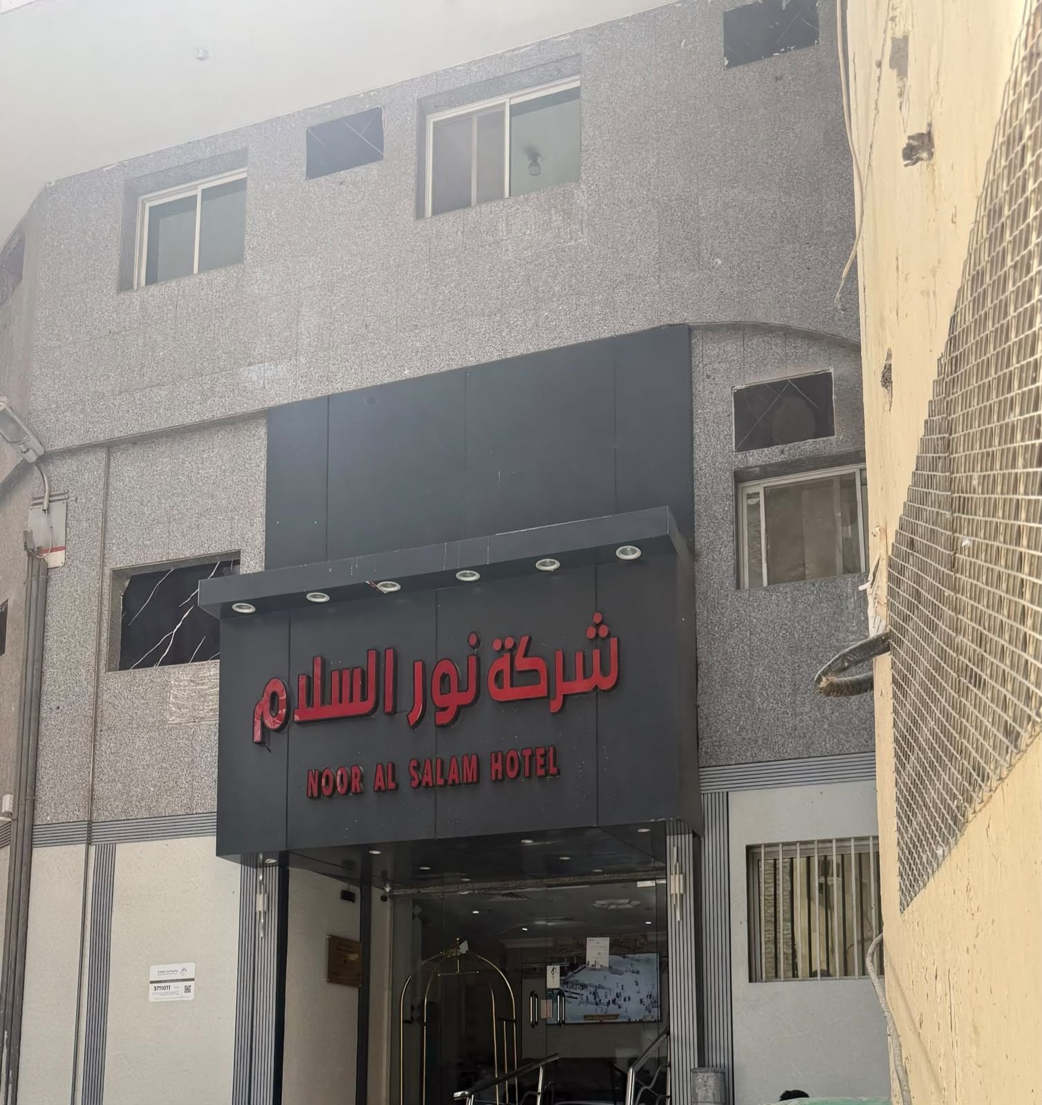The exterior of Noor Al Salam Hotel with a prominent sign in Arabic and English.
