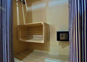 A room with a wooden bench against the wall, a control panel, and striped curtains. - Ocean Breeze Boutique Hotel (Nungwi)