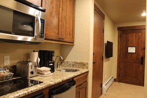 A compact kitchen with a microwave, toaster, coffee maker, and dishwasher. - Grand Lodge Peak 7 - 2 BR Condo at Independence Lift. Dec. 12th to Dec. 19th (Breckenridge)