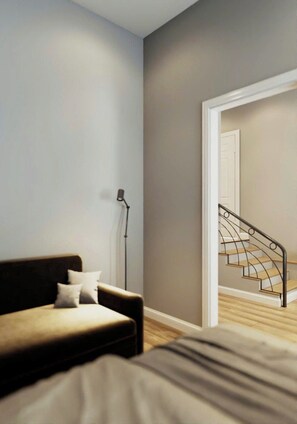 A bedroom with a bed, a sofa, a lamp, and a staircase. - Your Peaceful Durham Getaway – Near Duke, UNC & RTP (Durham)