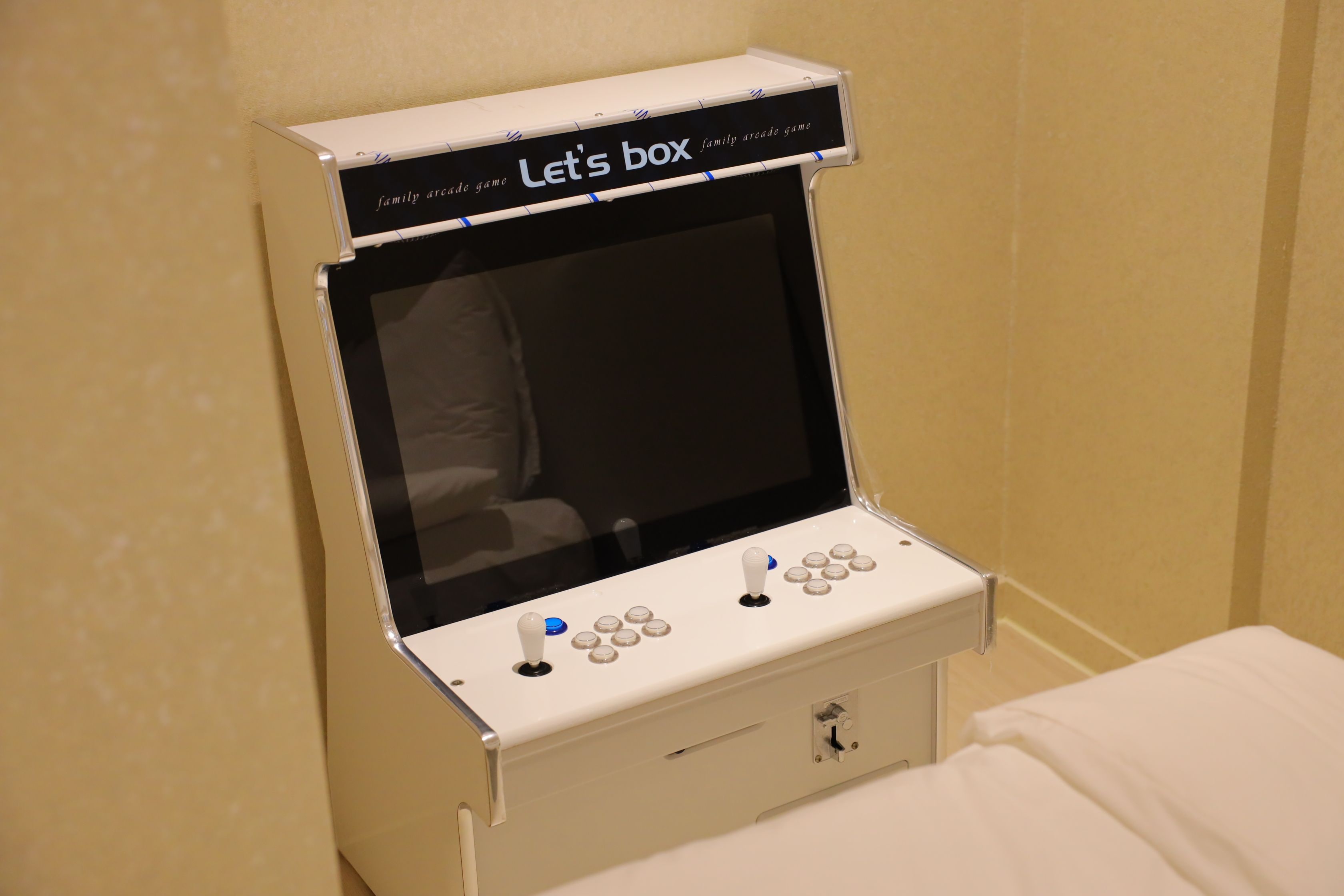 A family arcade game unit with a screen, joystick, and buttons.