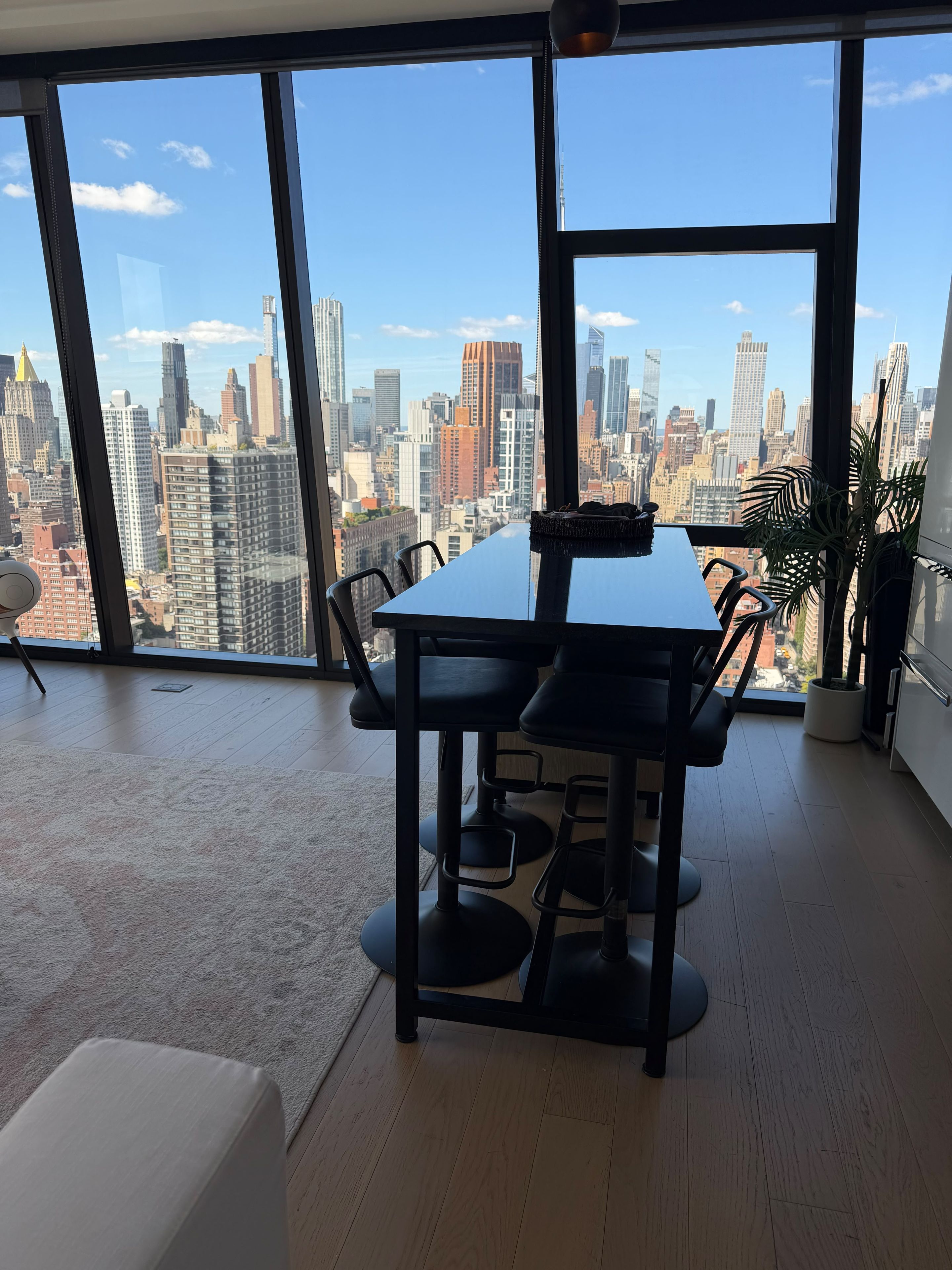 A modern office space with a large window overlooking a city skyline.