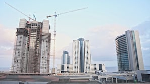 A construction site with a large building under scaffolding and a crane. - 2-bedroom apartment in charming Durban with AC for relaxing stays (Durban)