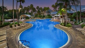 A large indoor swimming pool with multiple lounge areas and palm trees. - Spacious 2BR villa, 5 minutes to SeaWorld, 15 to Disney, pools and  full kitchen (Orlando)