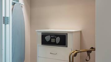 A laundry area with a washing machine, an iron, and a drying rack.