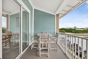 The private balcony overlooks a peaceful residential neighborhood. Gather around the high-top table with your morning coffee or evening cocktails and enjoy the serene coastal atmosphere. - Stone’s Throw | 3Min to Beach | Pool, Hot Tub (Mexico Beach)
