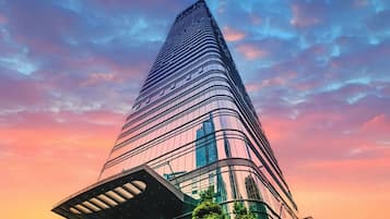 A tall, modern skyscraper with a curved facade and a distinctive architectural design.