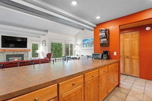 A kitchen with a large island, wooden cabinets, a built-in oven, and a coffee maker. - Breckenridge Mountain Retreat w/ Loft | Steps to Adventure (Breckenridge)
