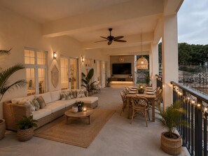 A spacious living area with a sofa, coffee table, and dining table set up for guests. - Luxurious 6 bed, 7 bath estate in Fitches Creek for large families and groups (Fitches Creek)