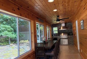 A wooden interior with a dining area, kitchen, and large windows. - Masthope  PA vacation retreat / Ski•Lake•Pool
come enjoy with family and friends (Lackawaxen)