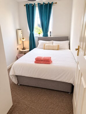 A neatly made bed with a white and grey duvet, a pink towel, and a grey headboard. - Entire 1 bed, zone 2, Peckham, Camberwell, Elephant and Castle (London)