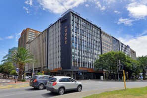 A modern hotel with a prominent 'Duke' sign, featuring a vertical facade with large windows and a flat roof. - Stylish 1Bed at The Duke with Rooftop Pool & Views in Cape Town (Cape Town)