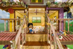 A child's playroom with a slide, a bed, and a window. - Luxury 15br Suites Pool and Themed Bedrooms (Orlando)