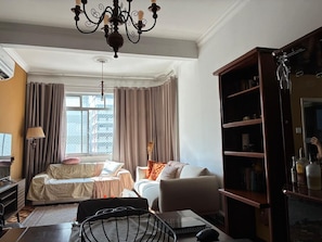 A room with a bed, a sofa, a desk, and a bookshelf. - Paulista | Entire apartment of 170 m², 3 bedrooms and parking space (São Paulo)