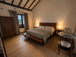 A bedroom with a bed, bedside tables, a chair, a desk, and a wardrobe. - Private Designer 3BR Villa in Battaramulla | Sleeps 7 | Near Colombo (Battaramulla)